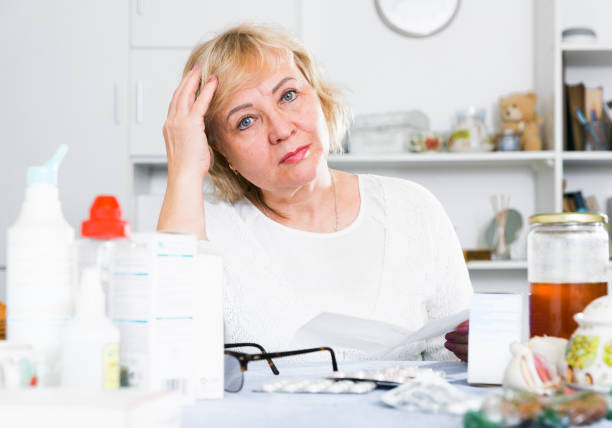 istock Mature woman with medicines and bills 1423180412