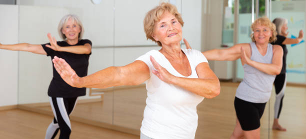 istock Cheerful senior woman enjoying active dancing in dance studio 1423180661