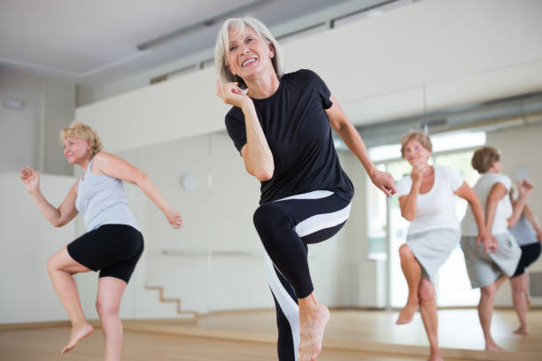 istock Portrait of mature energetic woman practicing active dancing at a group lesson 1423181177