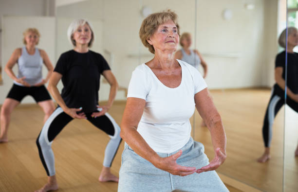 istock Elderly woman practicing ballet dance moves in choreographic studio 1423181180