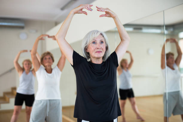 istock Mature active women perform ballet exercises in the studio 1423181184