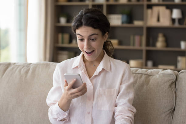 istock Woman staring at cellphone screen read message feels surprised 1423181504