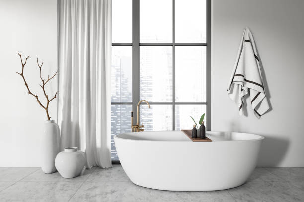 istock Light bathroom interior with tub and panoramic window, accessories 1423185950