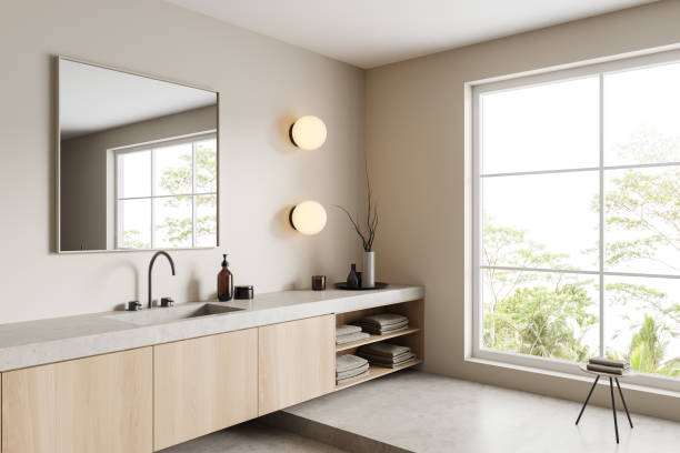 istock Light bathroom interior with sink and panoramic window, accessories on dresser 1423187087