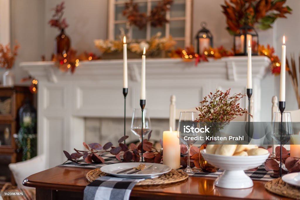 Thanksgiving dinner table decorated for fall Dinner table decorated for cozy fall holiday gathering Thanksgiving - Holiday Stock Photo