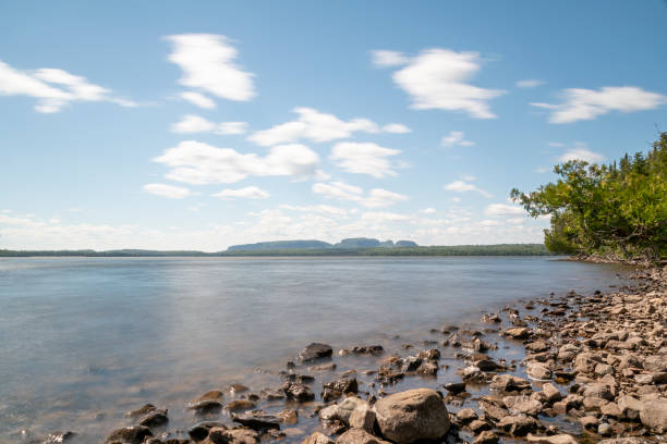 The mountain formation known as the Sleeping Giant is seen in the distance across a bay in Lake Superior on a bright sunny day.