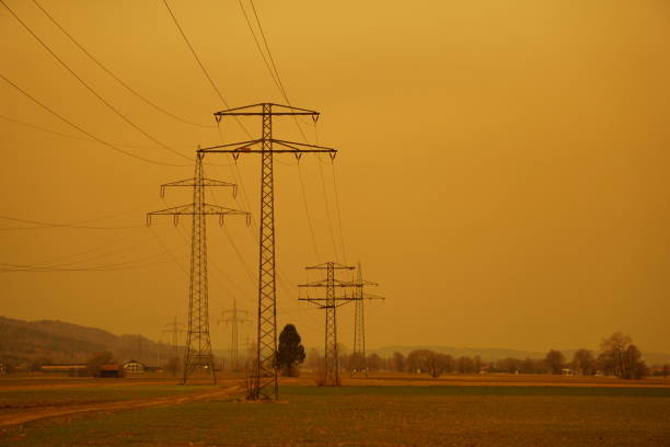 A sandstorm in Germany. A sandstorm in Europe. The air is brick-colored. Orange, brown sky from sand. A church in a sandstorm. Electric poles in a sandy blizzard. Yellow sky in a sandy blizzard. Ok