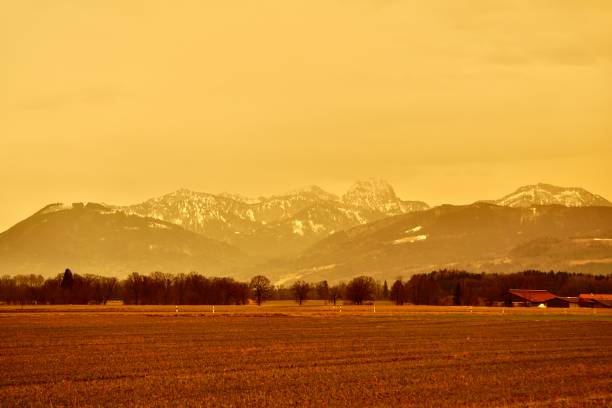 A sandstorm in Germany. A sandstorm in Europe. The air is brick-colored. Orange, brown sky from sand. A church in a sandstorm. Electric poles in a sandy blizzard. Yellow sky in a sandy blizzard. Ok