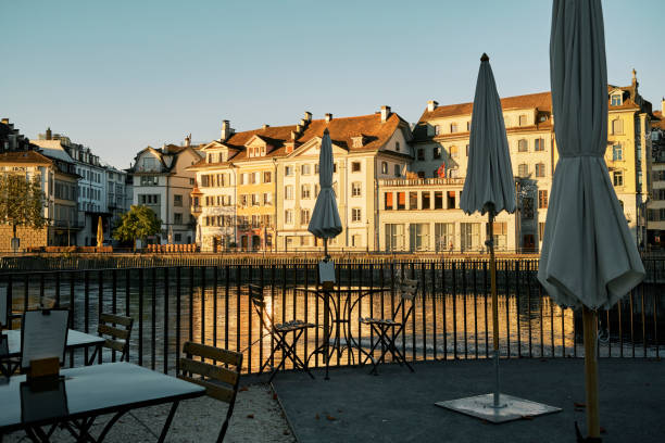 Empty cafe terrace at riverside in old town at sundown