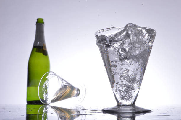 istock Glass of bubbling champagne and bottle 1423190594