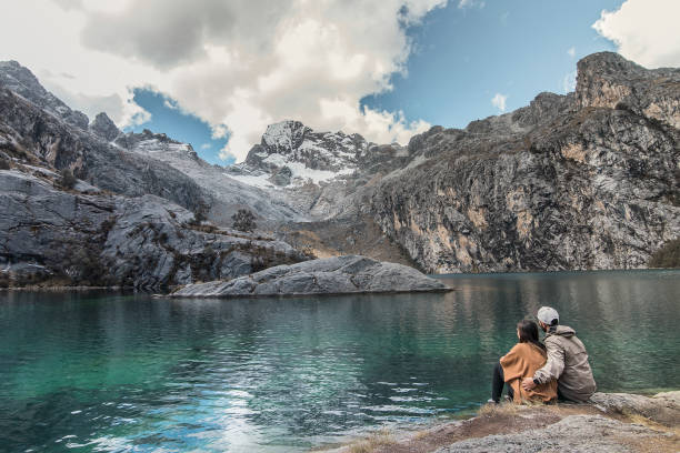 istock couple looking at a beautiful blue lake 1423196869