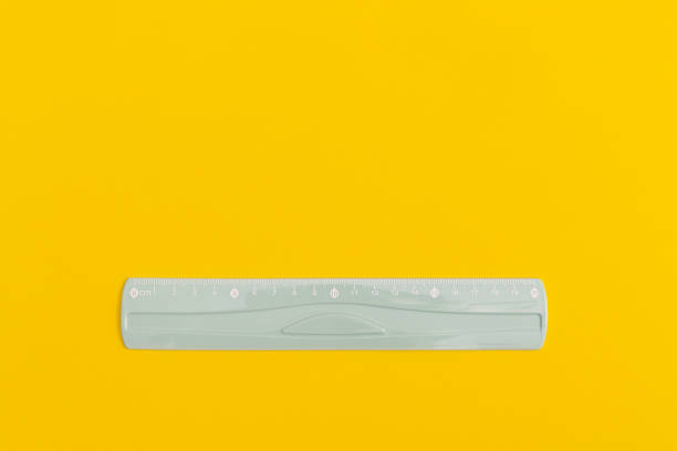 istock School black ruler on yellow background. Top view with copy space. Flat lay. Back to school concept. 1423200684