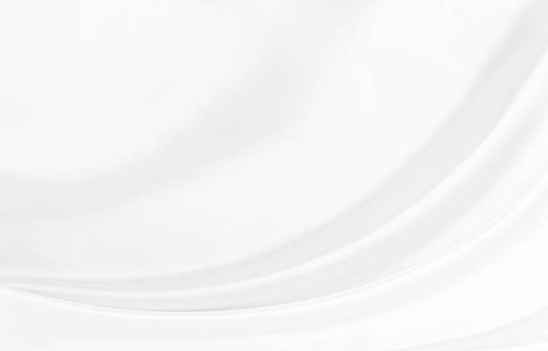 White gray satin texture that is white silver fabric silk background with beautiful soft blur pattern natural.