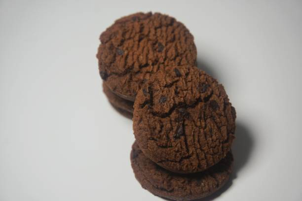 istock Selective focus, chocolate cookies on white table. Chocolate chip cookies shot 1423203644
