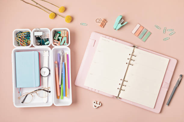 istock Home office desktop over pink background. Modern workspace with notebook, office stationary in plastic organizers 1423207354
