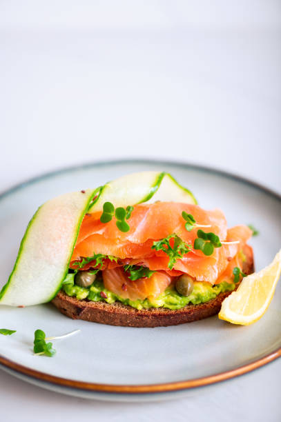 Toast with avocado and salmon stock photo