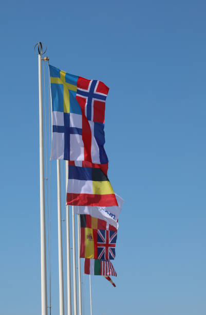 istock flags of many different nations flying against the blue sky 1423214272