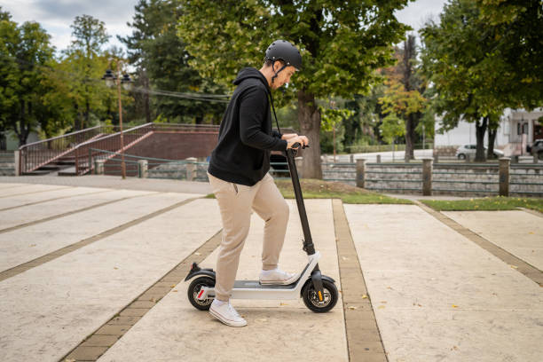 istock caucasian man drive or ride electric kick scooter e-scooter 1423223170
