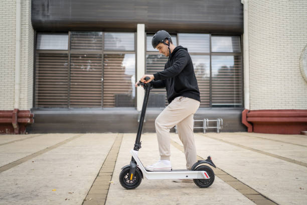 istock caucasian man drive or ride electric kick scooter e-scooter 1423223841