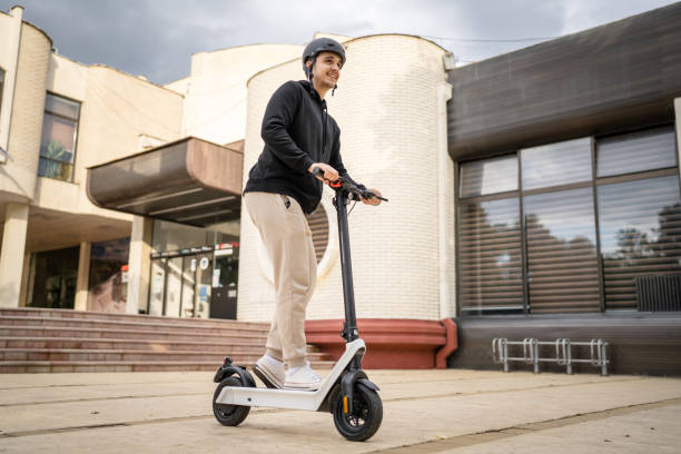 istock caucasian man drive or ride electric kick scooter e-scooter 1423224379