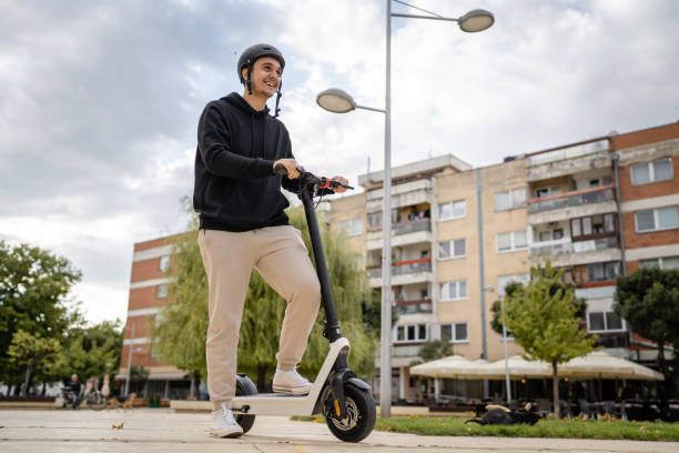 istock caucasian man drive or ride electric kick scooter e-scooter 1423224591