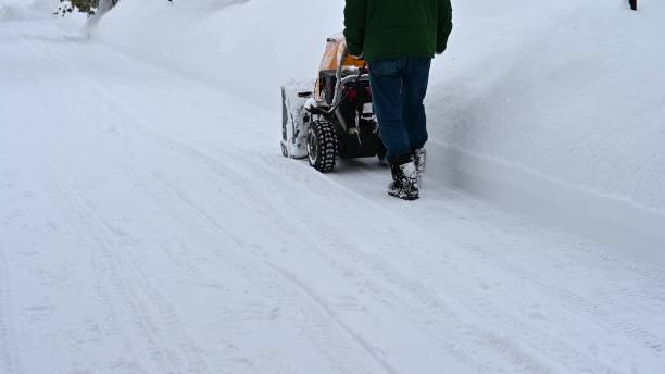 istock A road maintenance worker removes snow with a snow blower in a snowfall. 1423228942