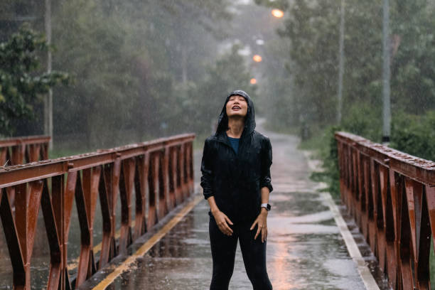 istock Asian ladies running in the rain 1423228950