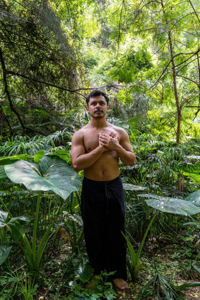 istock young man doing meditation on a stairway in a forest, mexico 1423232031
