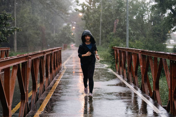 istock Asian ladies running in the rain 1423233564