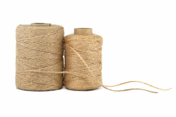 Twisted burlap jute twine rolls in close-up over a white background. Eco friendly biodegradable material
