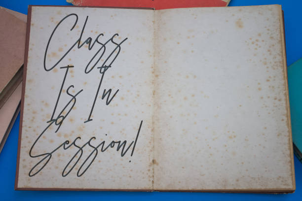istock Class Is In Session word in opened book with vintage, natural patterns old antique paper design. 1423241711