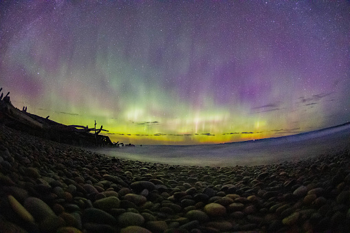 The northern lights or aurora borealis as seen from the coast of Lake Superior on the beach at Whitefish Point via a long exposure in September of 2022.