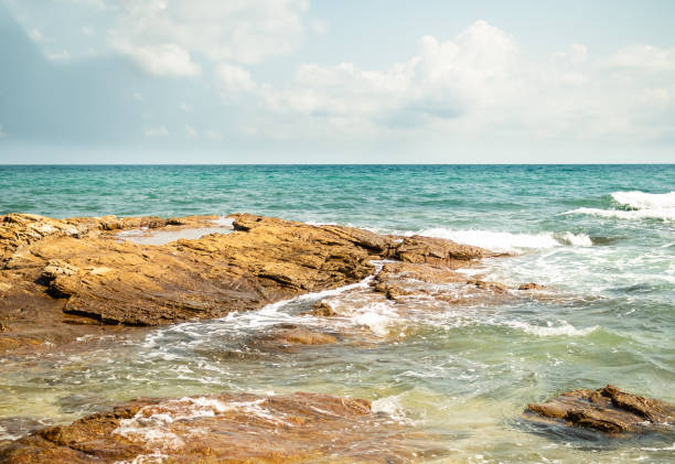 istock Wave on Stone,Blue Sky Background at Coast 1423244490