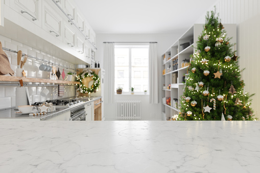 Empty White Marble Surface And Blurred Kitchen Background With Christmas Tree