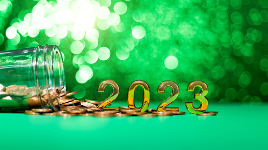 2023 new year and coin jar on the table.