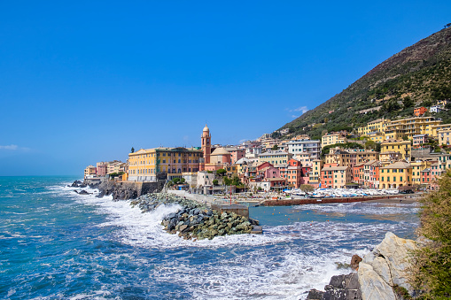Small harbor in Nervi, Genoa, bordered by colorful buildings - Italy