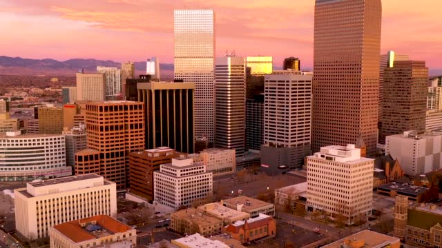 Timelapse - Aerial drone video of Denver Colorado under a fiery sunrise.