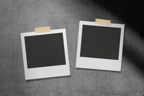 istock Shadow on concrete wall. A stylish template with instant photos taped to it. 1423253769