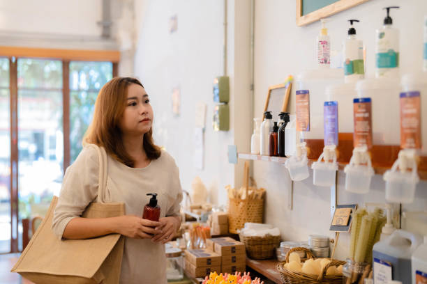 istock Asian woman refilling the shampoo while shopping in zero waste store. 1423254856