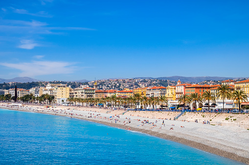 People sunbathing on the Ponchettes Public Beach in Nice
