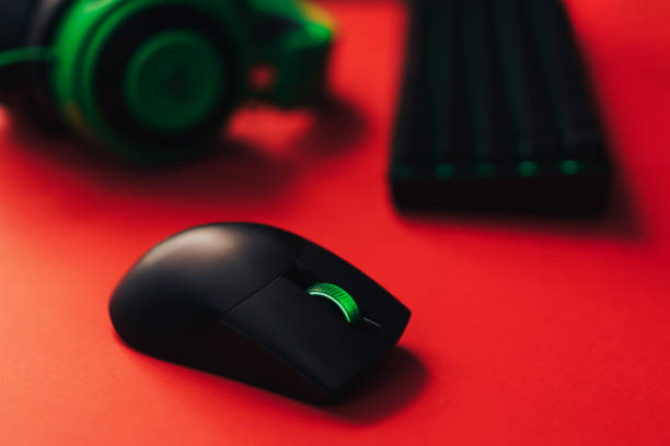 istock Gaming wireless accessories with green backlight on red background 1423256127