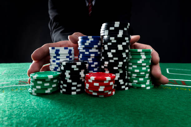 Businessman hands pushing gambling chips stock photo