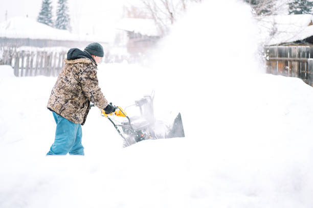 istock A man cleans the road from snow with a snowplow 1423256654