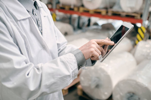 istock Hands touching tablet screen, working at factory 1423262904