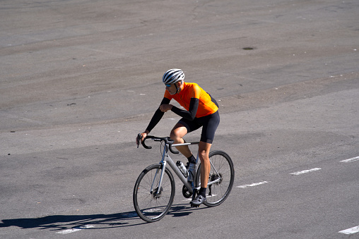 Man racing cyclist just arrived at summit of Swiss mountain pass Sustenpass on a sunny summer day. Photo taken July 13th, 2022, Susten Pass, Switzerland.