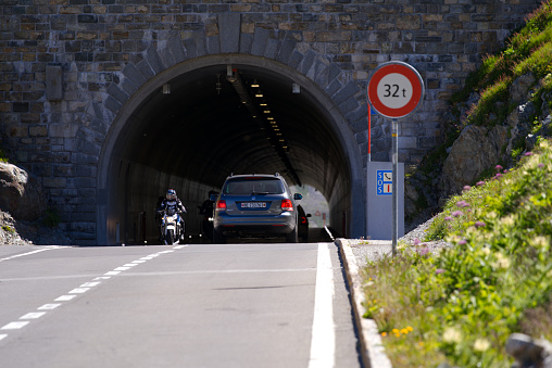 Tunnel at summit of Swiss mountain pass Sustenpass with cars and motorcycle on a sunny summer day. Photo taken July 13th, 2022, Susten Pass, Switzerland.