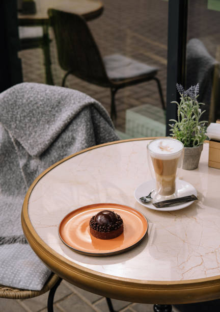 istock Latte coffee with cake on the table in the outdoor cafe 1423271775