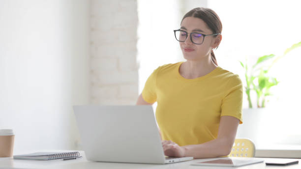 istock Woman having Back Pain while using Laptop in Office 1423272330