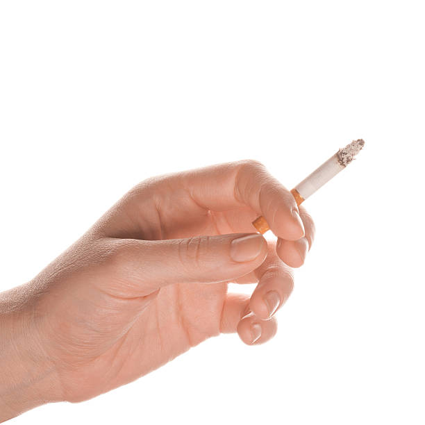 Woman's hand holding a cigarette stock photo