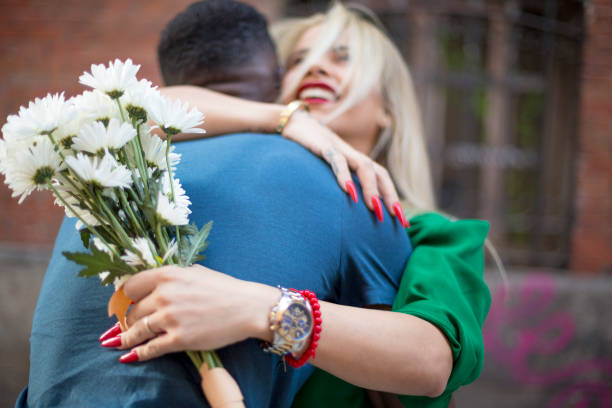 istock Multiethnic couple embraced in the street 1423273335